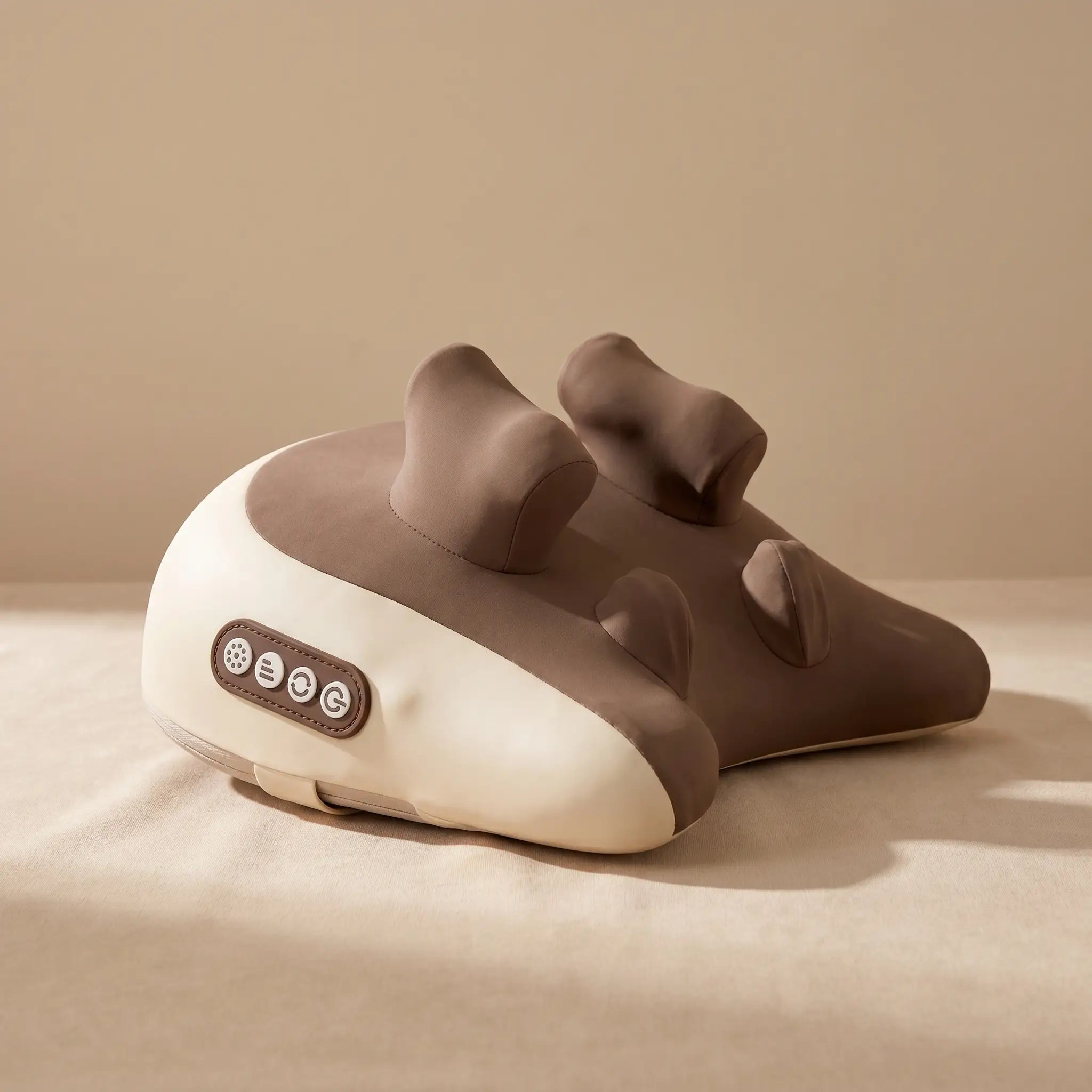 The Hizoo neck and shoulder massager on a warm minimal surface